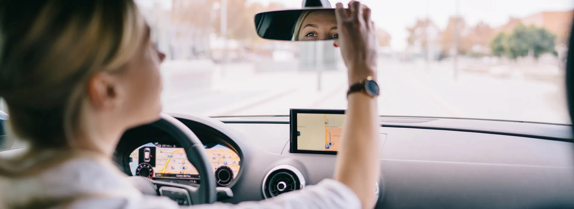 woman checking rear-view mirror